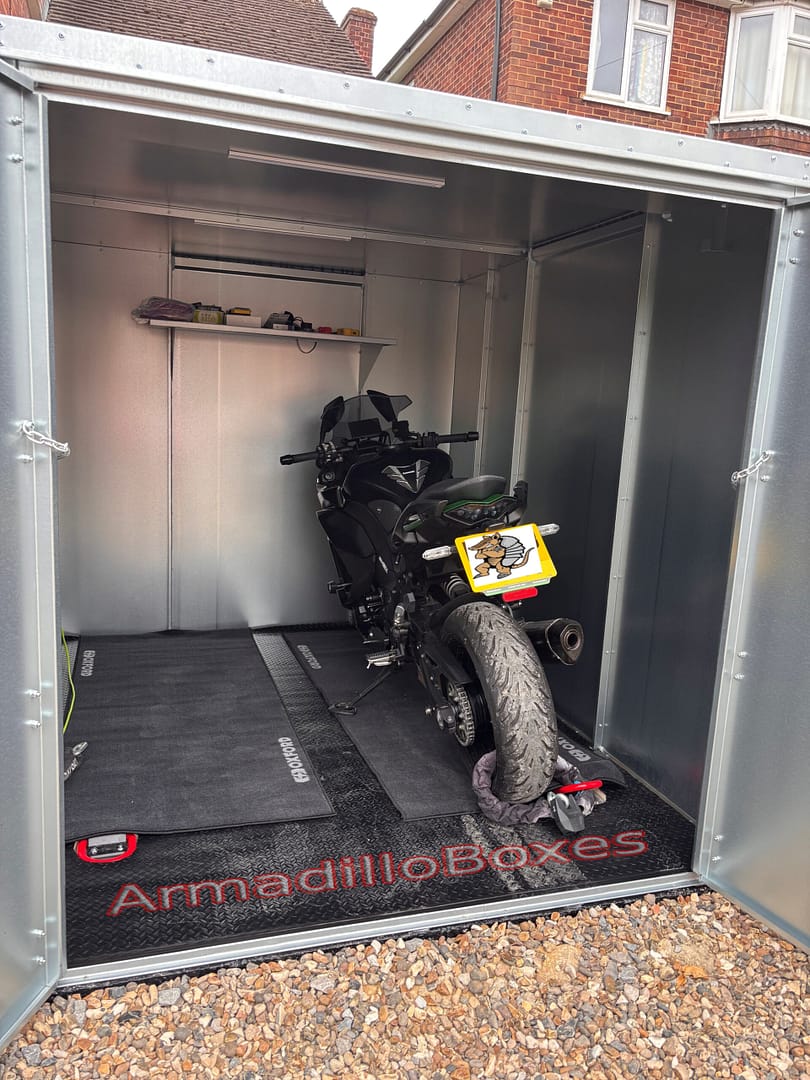 Single motorcycle stored inside an Armadilloboxes double-door galvanised steel motorcycle storage unit